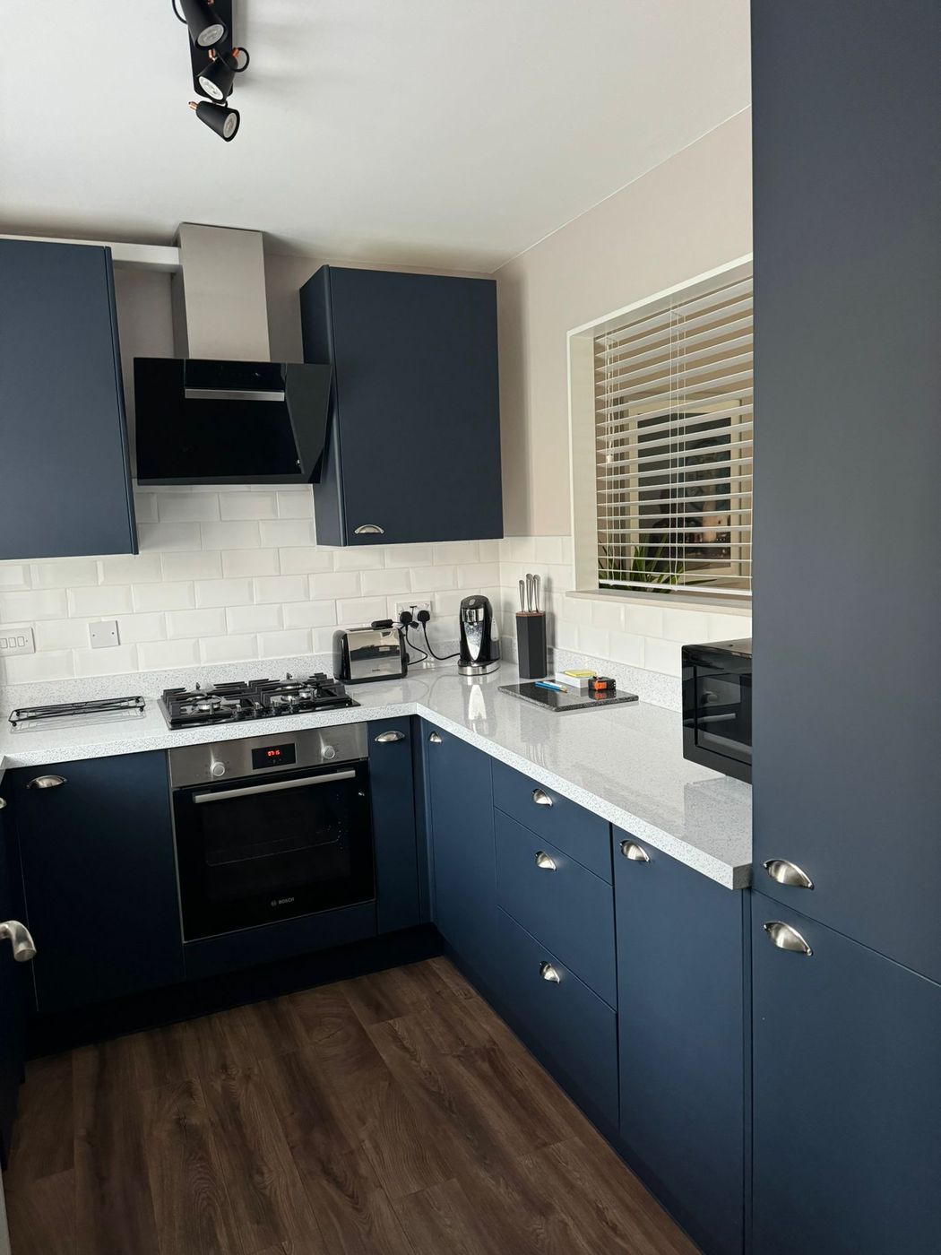 Kitchen refurbished by Lova, with navy units and quartz worktops